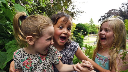 Three young girls laughing at Ascott, Buckinghamshire